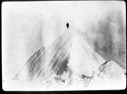 Image of Man atop high, sharp peak